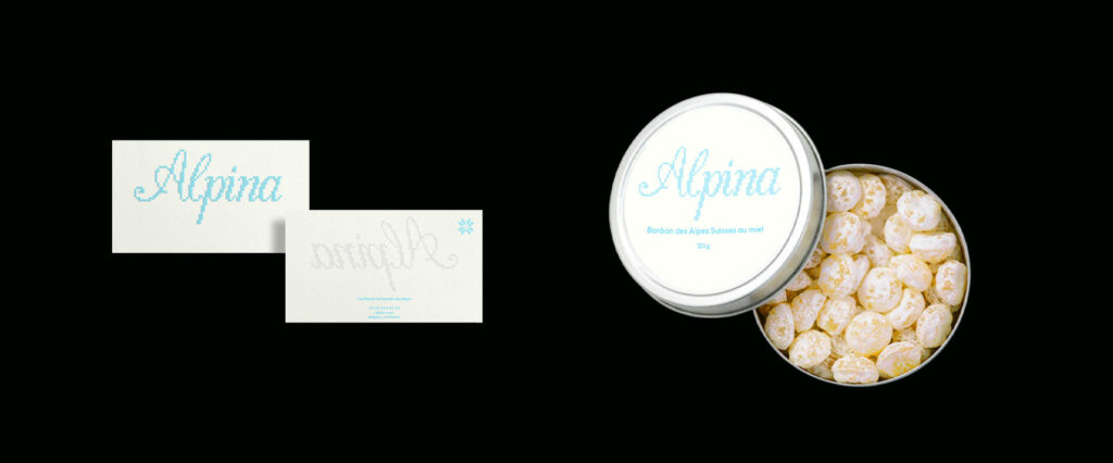 photo sur fond noir d'une carte de visite et d'une boite de bonbon en metal